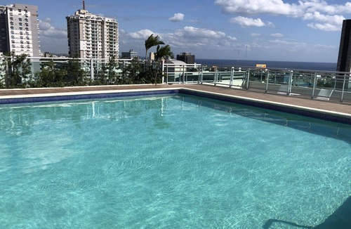 Downtown Santo Domingo Condo | Rooftop Pool with Ocean and City Views